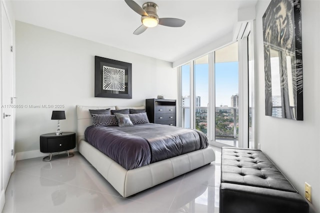 tiled bedroom with a wall of windows, a view of city, and a ceiling fan