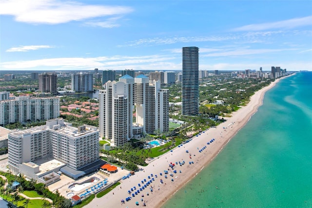 aerial view featuring a city view, a beach view, and a water view