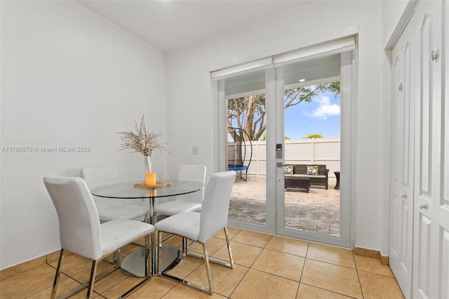 dining space featuring light tile patterned floors