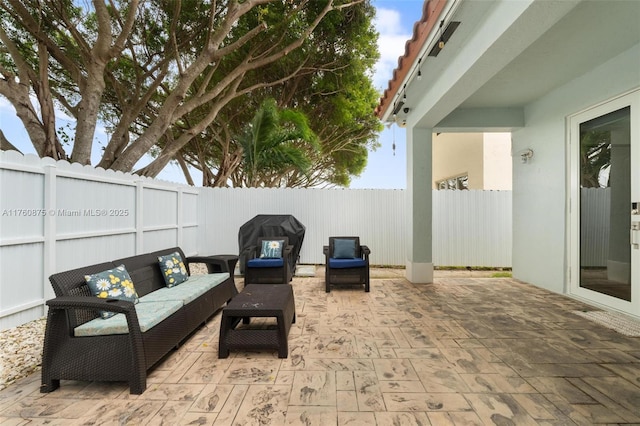 view of patio featuring an outdoor living space, a grill, and a fenced backyard