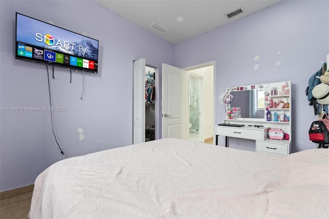 bedroom featuring visible vents and connected bathroom