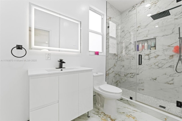 bathroom with vanity, toilet, marble finish floor, and a marble finish shower