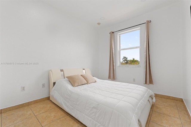 tiled bedroom featuring baseboards