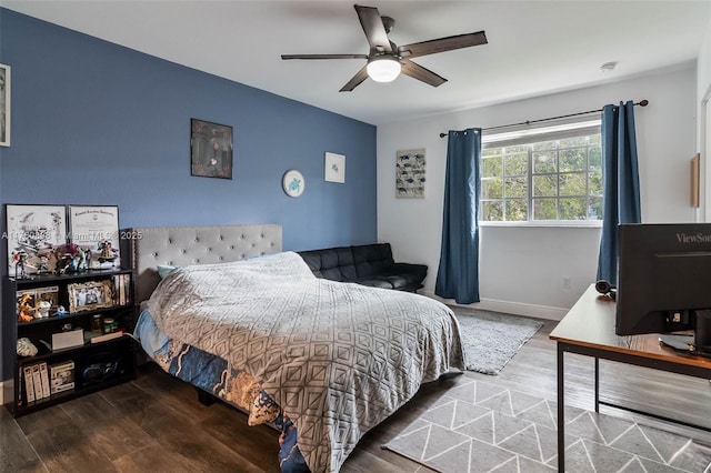 bedroom with baseboards, a ceiling fan, and wood finished floors