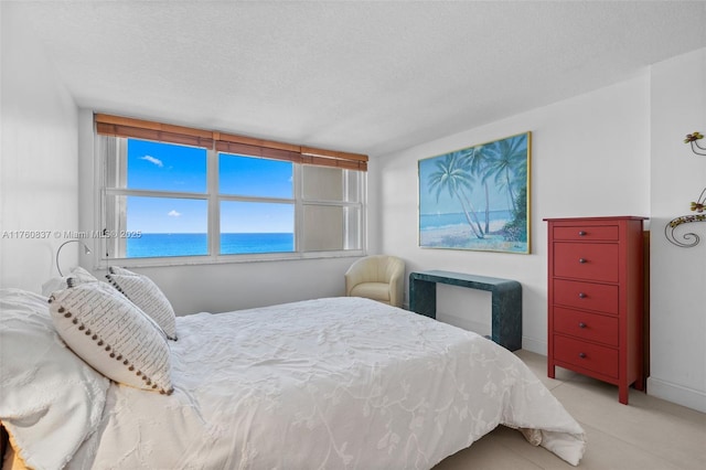 bedroom with a textured ceiling and baseboards