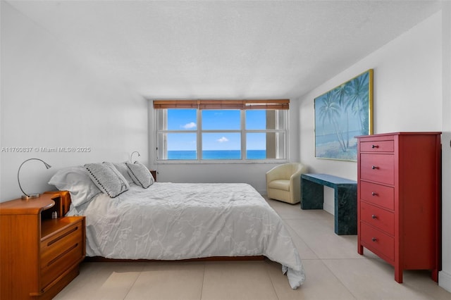 tiled bedroom featuring a textured ceiling