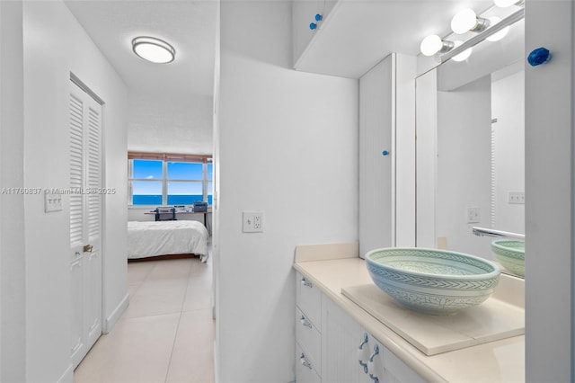 bathroom featuring vanity, tile patterned floors, and ensuite bathroom