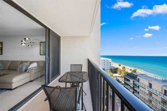 balcony with a water view and a beach view