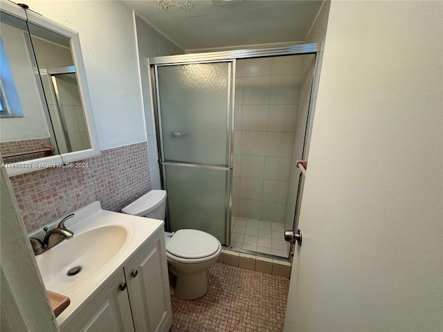 bathroom with toilet, tile walls, a stall shower, and tile patterned flooring