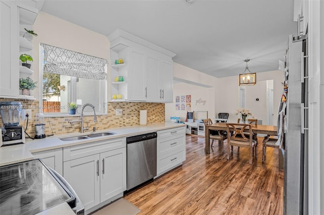 kitchen with a sink, white cabinets, dishwasher, and open shelves