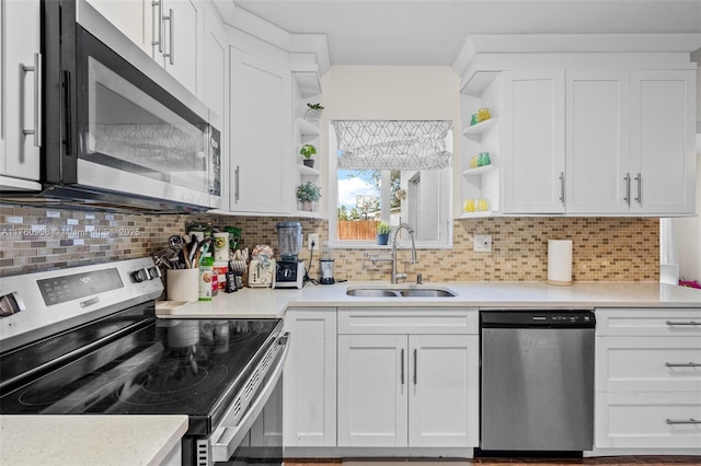 kitchen with open shelves, white cabinets, appliances with stainless steel finishes, and a sink