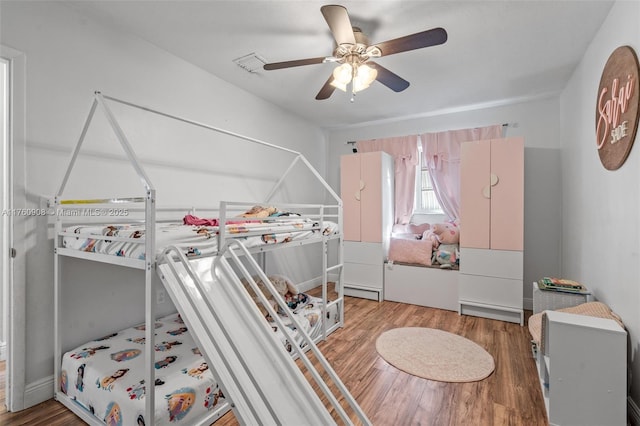 bedroom with a ceiling fan and wood finished floors