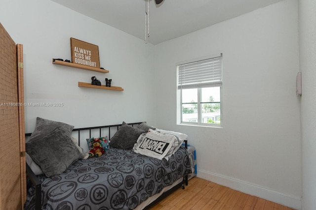 bedroom with light wood finished floors and baseboards