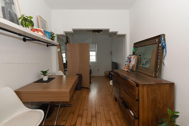 hallway with hardwood / wood-style flooring