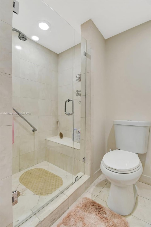 2000 Island Bl Unit 410, Aventura, FL 33160 - bathroom featuring tile patterned flooring, a stall shower, toilet, and baseboards