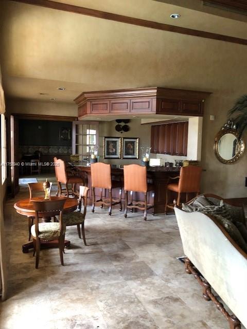 dining space featuring a towering ceiling