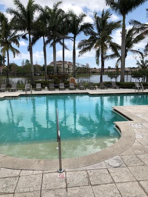 community pool featuring a patio area and fence