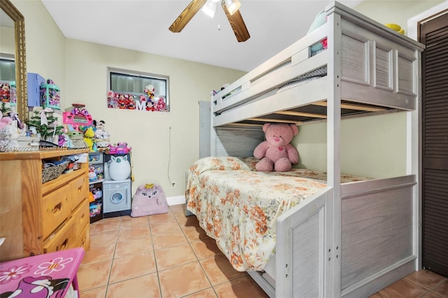 bedroom with light tile patterned floors, baseboards, and ceiling fan