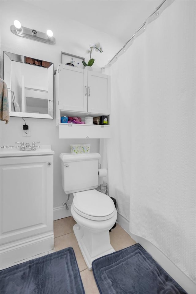 full bathroom with tile patterned floors, toilet, and vanity