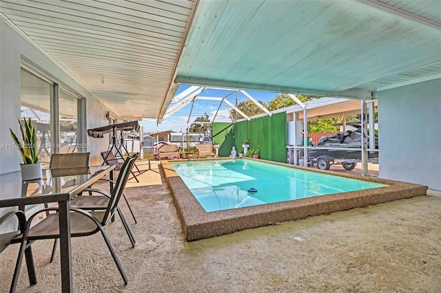 view of swimming pool with a patio, a fenced in pool, and a lanai