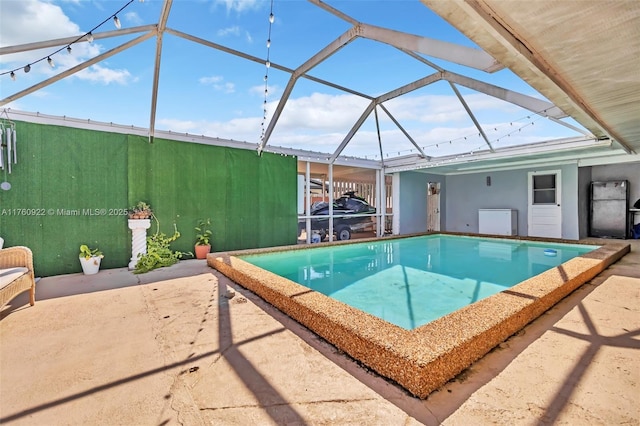 view of swimming pool with a lanai and a patio area