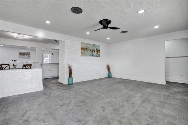 interior space featuring recessed lighting, a textured ceiling, concrete floors, and a ceiling fan