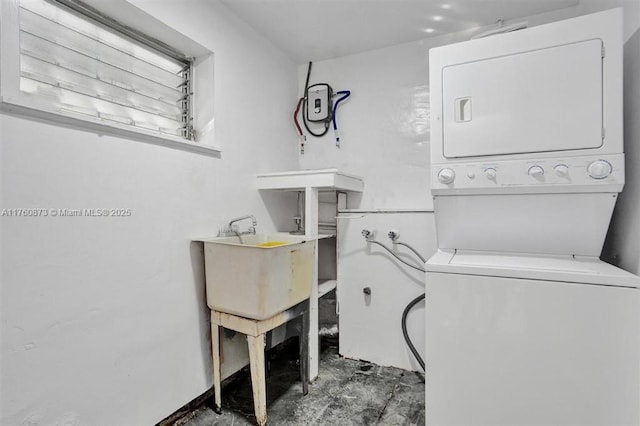 laundry room with stacked washer / drying machine