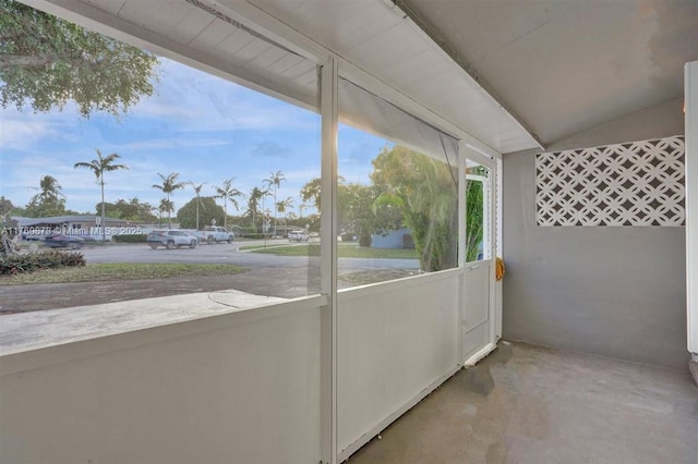 unfurnished sunroom with vaulted ceiling