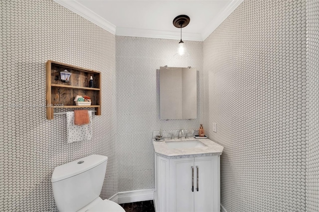 half bathroom with vanity, toilet, and crown molding