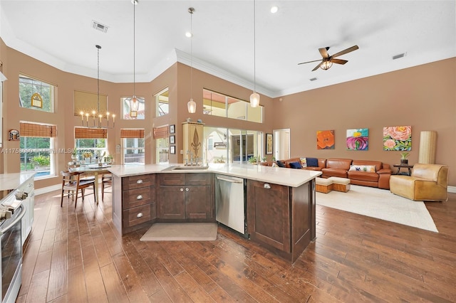 kitchen featuring dark brown cabinets, stainless steel appliances, visible vents, and light countertops