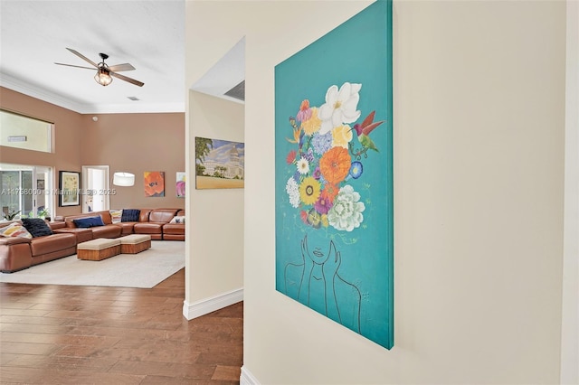 hall featuring crown molding, wood finished floors, and baseboards