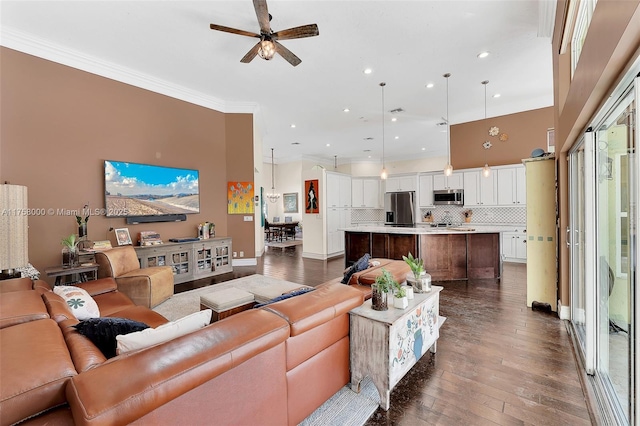 living area with a ceiling fan, recessed lighting, a high ceiling, crown molding, and dark wood-style flooring