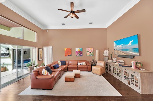 living room featuring dark wood finished floors, crown molding, visible vents, and ceiling fan