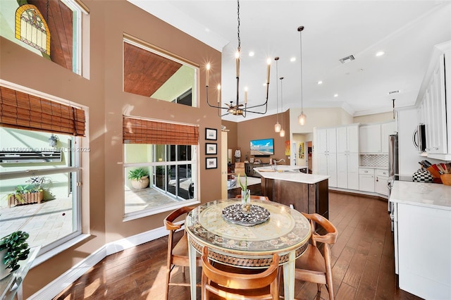 dining space featuring an inviting chandelier, baseboards, visible vents, and dark wood-style flooring