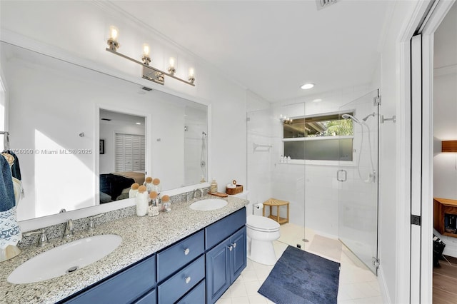 full bathroom with double vanity, connected bathroom, a shower stall, and a sink