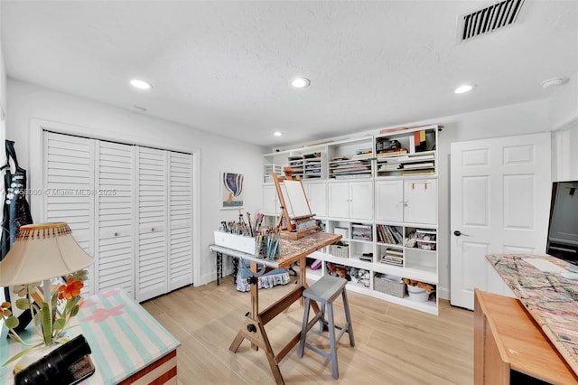 office area with recessed lighting, visible vents, light wood-style floors, and a textured ceiling