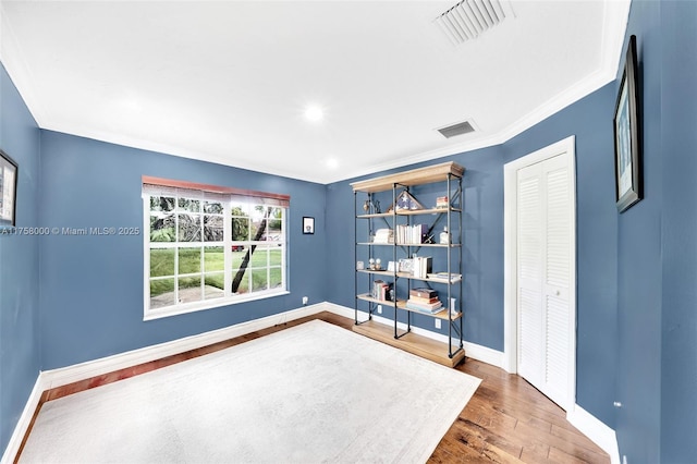 interior space with visible vents, baseboards, and wood finished floors