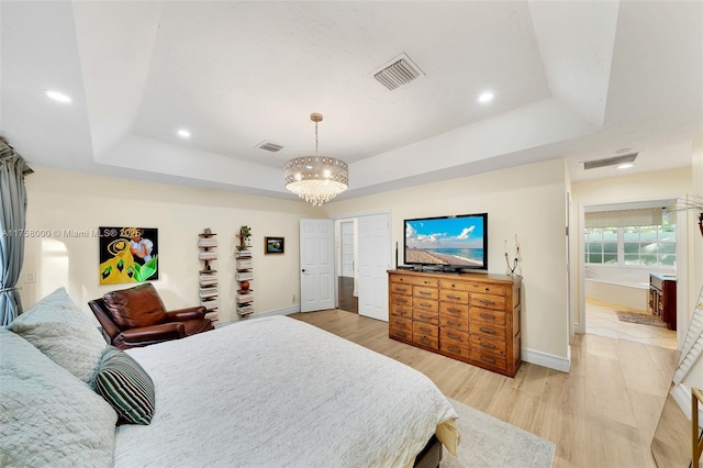 bedroom featuring visible vents, recessed lighting, a raised ceiling, and light wood-style floors