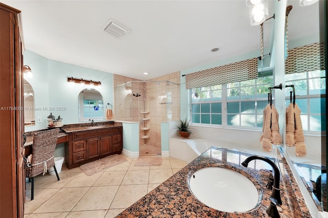 bathroom featuring tile patterned floors, visible vents, a stall shower, and vanity