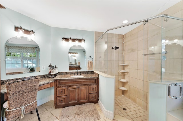 bathroom with tile patterned floors, vanity, and a shower stall