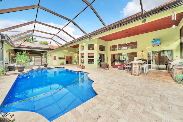 pool with ceiling fan, a lanai, and a patio area