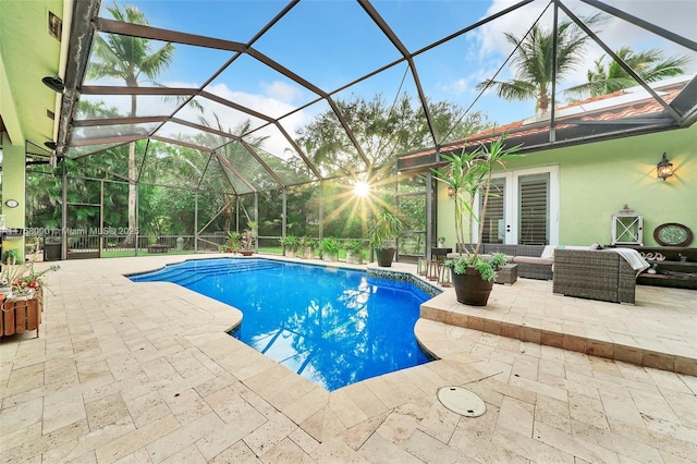 outdoor pool with a patio, a lanai, and outdoor lounge area