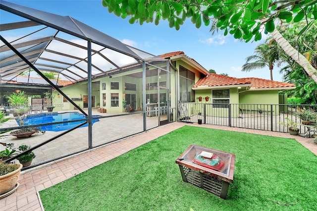 back of house featuring a patio, a lawn, fence, and a tile roof