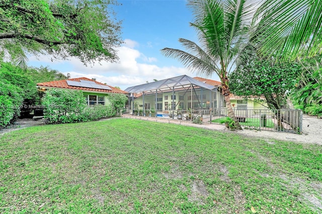 view of yard featuring glass enclosure, fence, and an outdoor pool