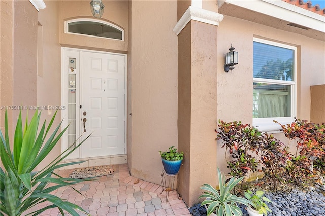 property entrance featuring stucco siding