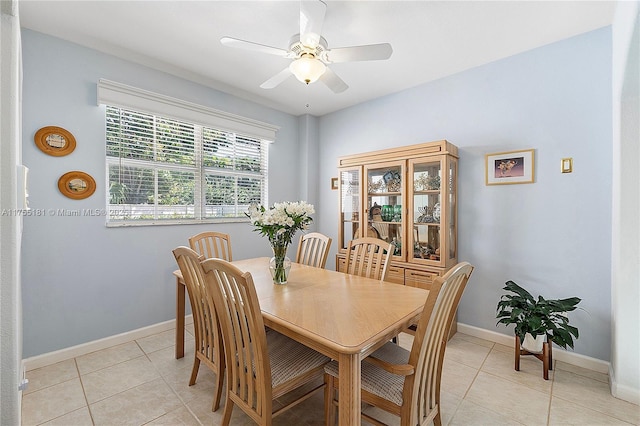 dining room featuring light tile patterned floors, a ceiling fan, and baseboards