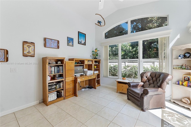 office with light tile patterned floors, high vaulted ceiling, and baseboards