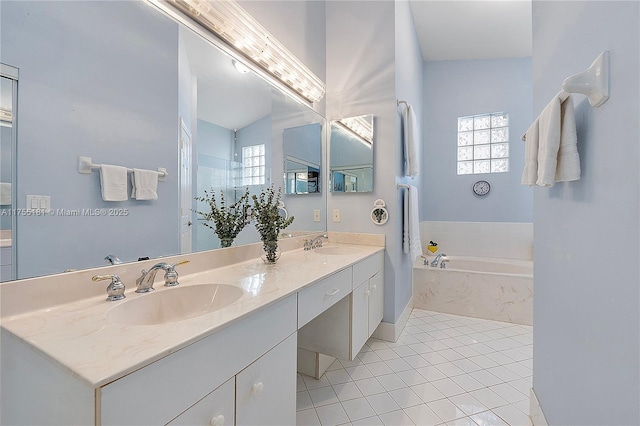 bathroom featuring tile patterned floors, double vanity, a garden tub, and a sink