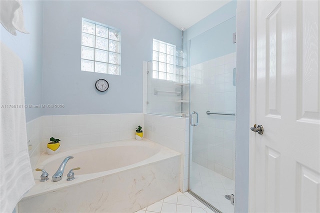 bathroom featuring a shower stall and a garden tub