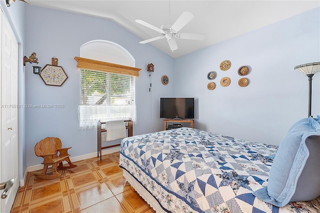 bedroom featuring vaulted ceiling, baseboards, and ceiling fan